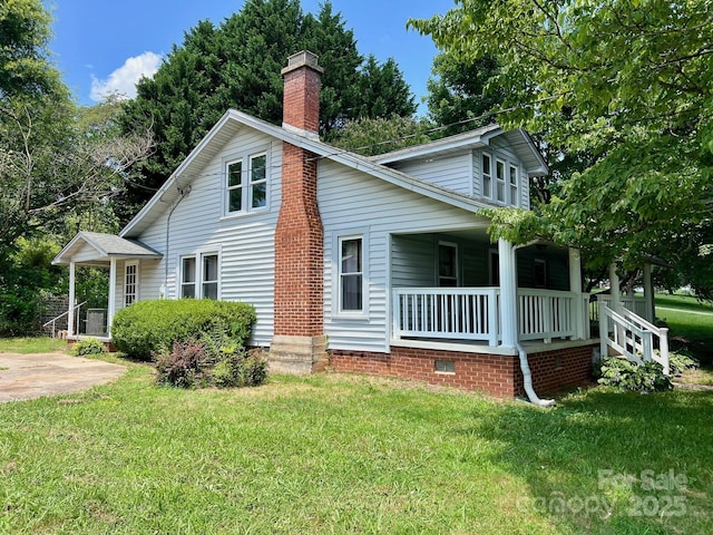 67 N Highland Ave, Granite Falls, NC 28630 - view of side of home featuring a porch, a lawn, and a chimney