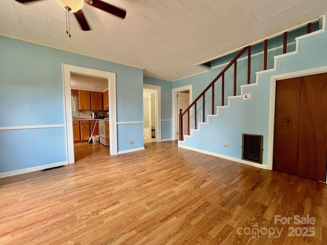 67 N Highland Ave, Granite Falls, NC 28630 - unfurnished living room with wood finished floors, stairs, and ceiling fan