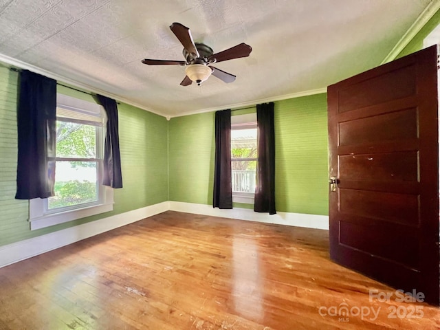 67 N Highland Ave, Granite Falls, NC 28630 - spare room with hardwood / wood-style floors, ornamental molding, and a ceiling fan