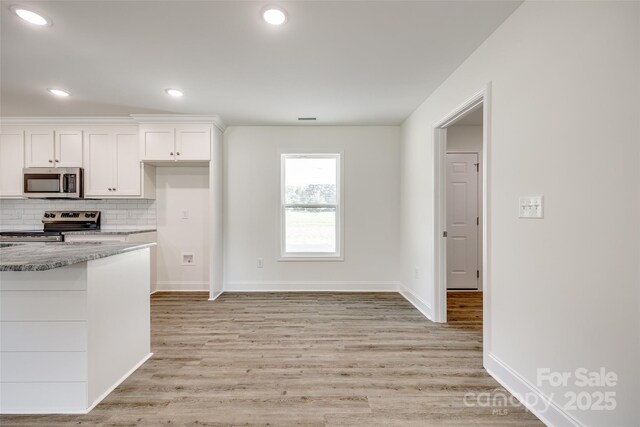 3248 Ferguson Long Rd, York, SC 29745 - kitchen featuring stainless steel appliances, white cabinets, backsplash, light wood-type flooring, and recessed lighting