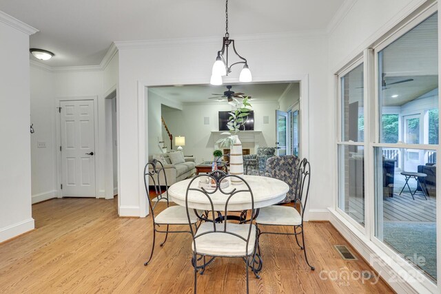 5051 Carillon Way, Charlotte, NC 28270 - dining area featuring light wood-type flooring, a ceiling fan, ornamental molding, and stairs