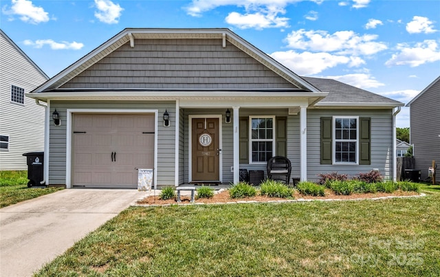 5967 Odenton Ln, Pfafftown, NC 27040 - view of front of home with a front lawn, a porch, concrete driveway, and an attached garage