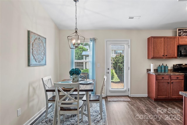 5967 Odenton Ln, Pfafftown, NC 27040 - dining area featuring dark wood-style floors and a chandelier
