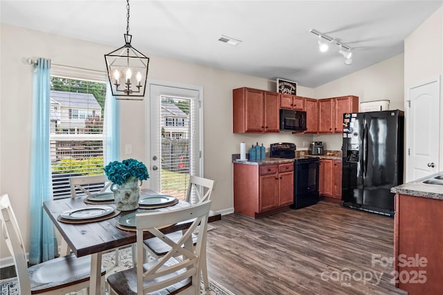 5967 Odenton Ln, Pfafftown, NC 27040 - kitchen with black appliances, a chandelier, dark wood-style floors, rail lighting, and vaulted ceiling