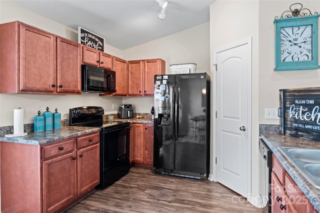 5967 Odenton Ln, Pfafftown, NC 27040 - kitchen with black appliances, dark wood-type flooring, lofted ceiling, brown cabinetry, and dark countertops