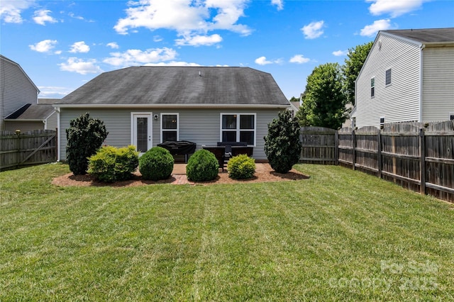 5967 Odenton Ln, Pfafftown, NC 27040 - rear view of house featuring a fenced backyard, a patio, and a shingled roof