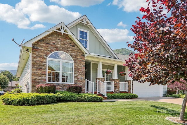 8 Amos Ct, Maggie Valley, NC 28751 - craftsman house featuring board and batten siding, covered porch, stone siding, concrete driveway, and a front lawn