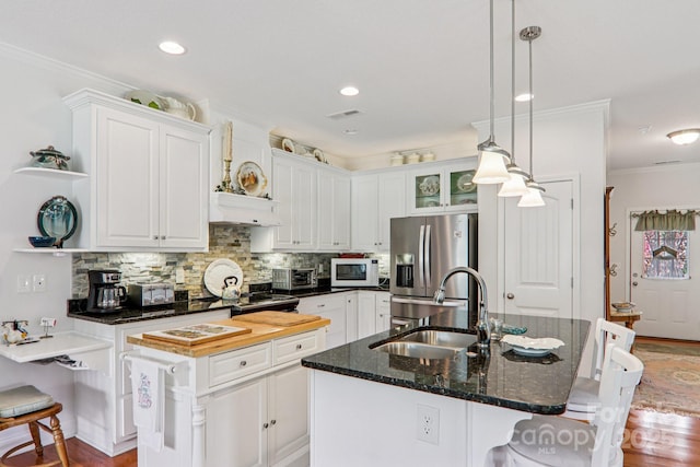 8 Amos Ct, Maggie Valley, NC 28751 - kitchen featuring stainless steel refrigerator with ice dispenser, white microwave, open shelves, ornamental molding, and backsplash