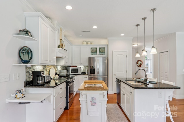 8 Amos Ct, Maggie Valley, NC 28751 - kitchen with appliances with stainless steel finishes, a center island with sink, open shelves, decorative backsplash, and crown molding