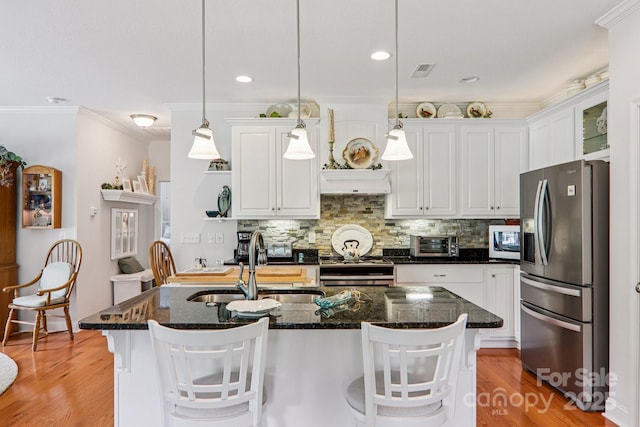 8 Amos Ct, Maggie Valley, NC 28751 - kitchen featuring stainless steel fridge with ice dispenser, white cabinetry, backsplash, ornamental molding, and light wood-type flooring