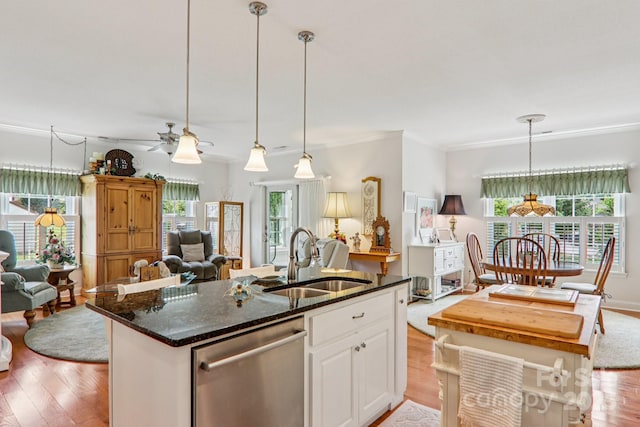 8 Amos Ct, Maggie Valley, NC 28751 - kitchen with stainless steel dishwasher, open floor plan, light wood finished floors, a center island with sink, and ornamental molding