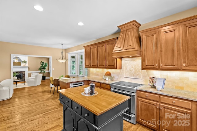 1019 Westlake Dr, Kannapolis, NC 28081 - kitchen featuring electric stove, custom range hood, butcher block countertops, tasteful backsplash, and recessed lighting
