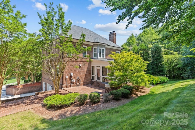 1019 Westlake Dr, Kannapolis, NC 28081 - rear view of property with a garage, a chimney, a patio, a lawn, and brick siding