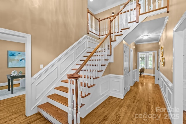 1019 Westlake Dr, Kannapolis, NC 28081 - stairs featuring crown molding, wood finished floors, a wainscoted wall, and a high ceiling
