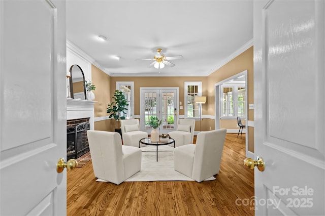 1019 Westlake Dr, Kannapolis, NC 28081 - living area featuring crown molding, ceiling fan, wood finished floors, a brick fireplace, and french doors