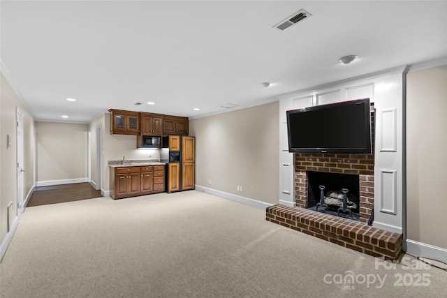 1019 Westlake Dr, Kannapolis, NC 28081 - unfurnished living room with ornamental molding, light carpet, a brick fireplace, and recessed lighting