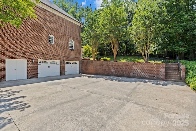 1019 Westlake Dr, Kannapolis, NC 28081 - view of side of property with a garage, driveway, and brick siding