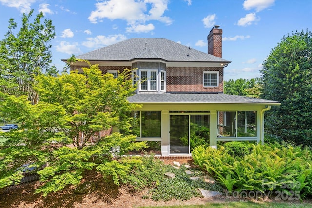 1019 Westlake Dr, Kannapolis, NC 28081 - back of property featuring roof with shingles, a chimney, brick siding, and a sunroom
