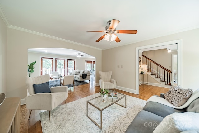 6412 Boykin Spaniel Rd, Charlotte, NC 28277 - living room with ceiling fan, ornamental molding, arched walkways, stairs, and wood finished floors