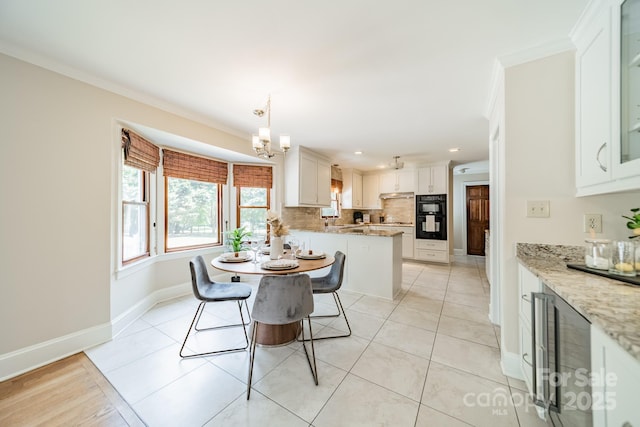 6412 Boykin Spaniel Rd, Charlotte, NC 28277 - dining space featuring crown molding, recessed lighting, a chandelier, light tile patterned flooring, and a dry bar