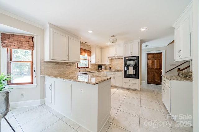 6412 Boykin Spaniel Rd, Charlotte, NC 28277 - kitchen with backsplash, a peninsula, light stone counters, white cabinetry, and crown molding