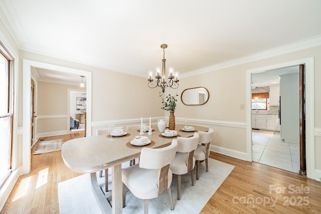 6412 Boykin Spaniel Rd, Charlotte, NC 28277 - dining area with a chandelier, crown molding, and light wood-style flooring