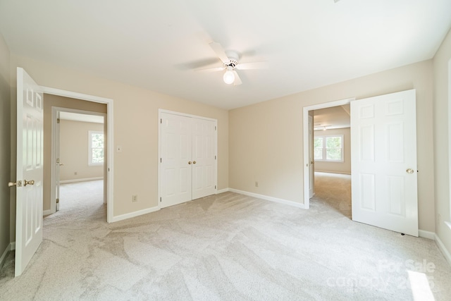 6412 Boykin Spaniel Rd, Charlotte, NC 28277 - unfurnished bedroom with light colored carpet, multiple windows, and a ceiling fan