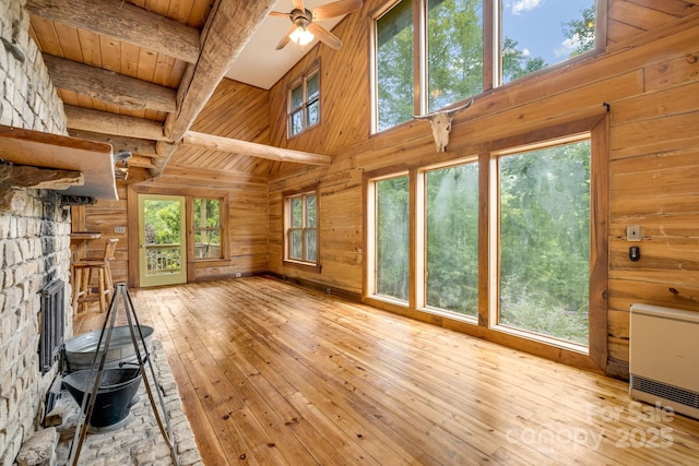 465 Youngs Gap Rd, Fletcher, NC 28732 - unfurnished living room with wooden walls, heating unit, light wood finished floors, a high ceiling, and a ceiling fan
