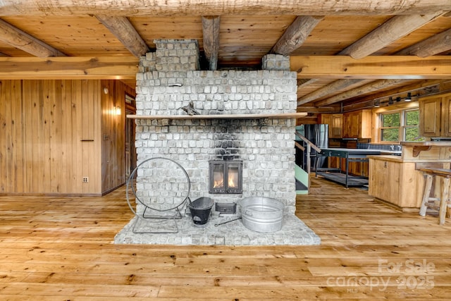 465 Youngs Gap Rd, Fletcher, NC 28732 - detailed view of freestanding refrigerator, wood finished floors, a wood ceiling with exposed beams, a fireplace, and wood walls