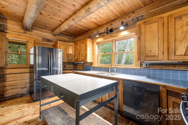 465 Youngs Gap Rd, Fletcher, NC 28732 - kitchen with dishwashing machine, freestanding refrigerator, tile countertops, a wood ceiling with exposed beams, and plenty of natural light