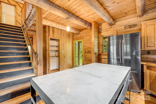 465 Youngs Gap Rd, Fletcher, NC 28732 - kitchen featuring freestanding refrigerator, a wood ceiling with exposed beams, wood walls, light wood finished floors, and a kitchen island