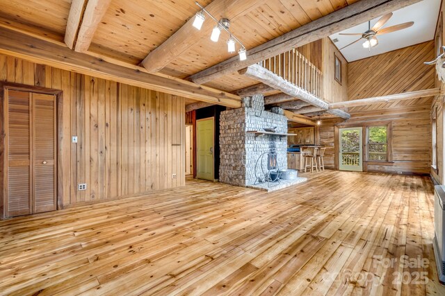 465 Youngs Gap Rd, Fletcher, NC 28732 - unfurnished living room with hardwood / wood-style flooring, wooden walls, ceiling fan, and a wood ceiling with exposed beams