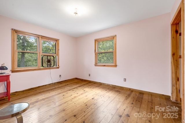465 Youngs Gap Rd, Fletcher, NC 28732 - unfurnished bedroom featuring multiple windows and hardwood / wood-style floors