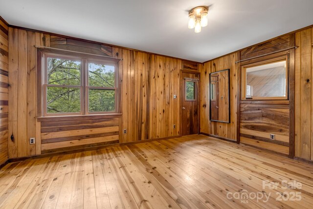 465 Youngs Gap Rd, Fletcher, NC 28732 - spare room featuring light wood finished floors and wood walls