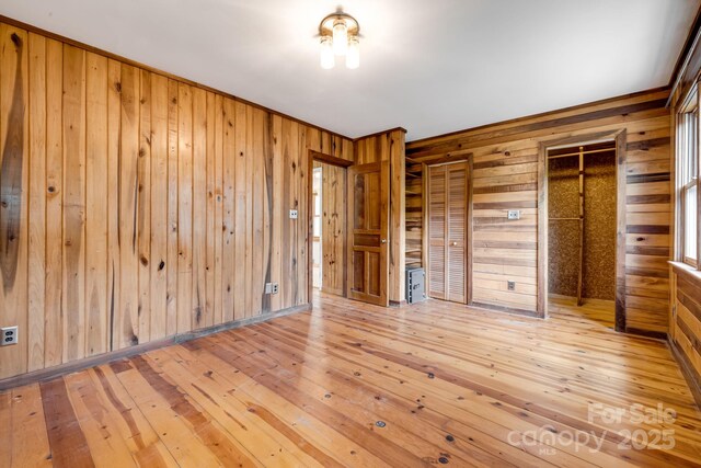 465 Youngs Gap Rd, Fletcher, NC 28732 - unfurnished bedroom with wooden walls, wood-type flooring, and crown molding