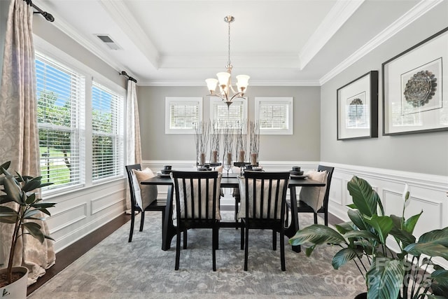 2377 Maple Grove Ln NW, Concord, NC 28027 - dining area with wood finished floors, a chandelier, ornamental molding, a wainscoted wall, and a raised ceiling