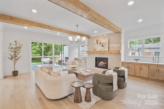 4349 Castleton Rd, Charlotte, NC 28211 - living room featuring beam ceiling, a warm lit fireplace, light wood-style flooring, recessed lighting, and a chandelier