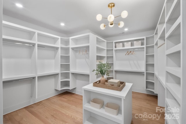 4349 Castleton Rd, Charlotte, NC 28211 - walk in closet featuring wood finished floors and a chandelier