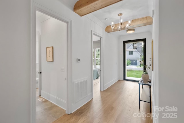 4349 Castleton Rd, Charlotte, NC 28211 - foyer with beam ceiling, a chandelier, and light wood-style floors