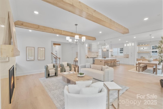 4349 Castleton Rd, Charlotte, NC 28211 - living area featuring light wood finished floors, recessed lighting, beam ceiling, a fireplace, and a chandelier