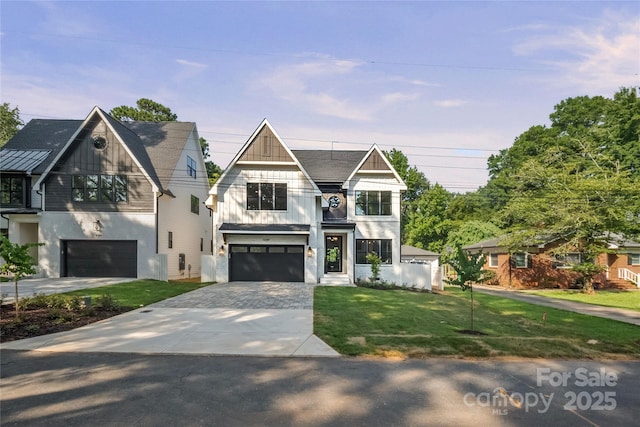 4349 Castleton Rd, Charlotte, NC 28211 - view of front facade featuring board and batten siding, an attached garage, a front yard, and driveway