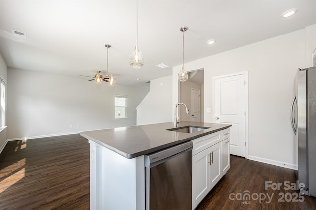 1209 Cathey Rd, Charlotte, NC 28214 - kitchen featuring appliances with stainless steel finishes, dark wood-type flooring, dark countertops, white cabinets, and pendant lighting