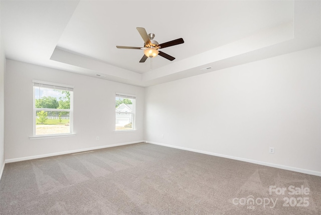 1209 Cathey Rd, Charlotte, NC 28214 - spare room featuring a tray ceiling, carpet, and ceiling fan