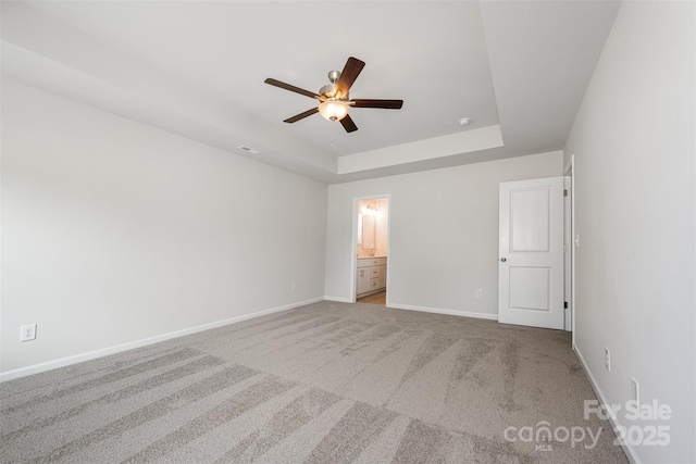 1209 Cathey Rd, Charlotte, NC 28214 - unfurnished bedroom with carpet, a tray ceiling, connected bathroom, and a ceiling fan
