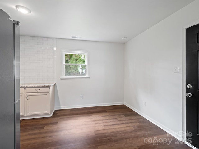 405 Jones St, Monroe, NC 28110 - unfurnished dining area featuring dark wood-type flooring and baseboards