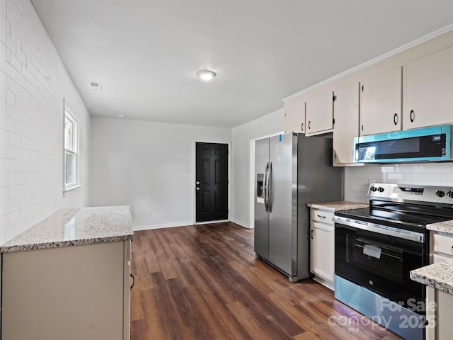 405 Jones St, Monroe, NC 28110 - kitchen featuring appliances with stainless steel finishes, backsplash, dark wood-type flooring, and light stone countertops