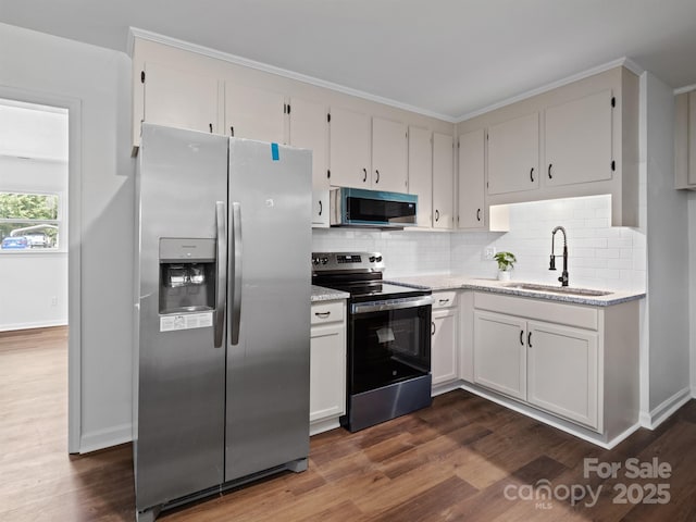 405 Jones St, Monroe, NC 28110 - kitchen featuring appliances with stainless steel finishes, backsplash, dark wood-style flooring, white cabinetry, and light stone counters