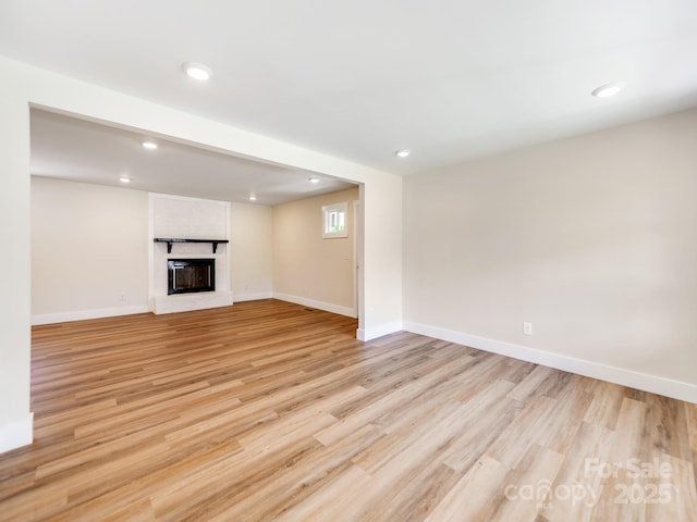 1606 N Rhyne St, Gastonia, NC 28054 - unfurnished living room featuring recessed lighting, light wood-style floors, and a fireplace