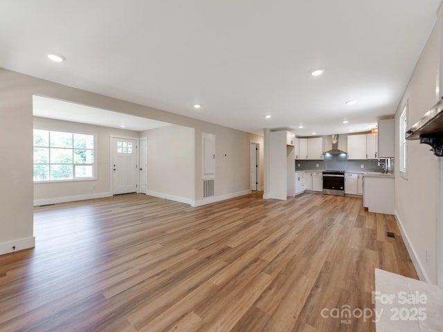 1606 N Rhyne St, Gastonia, NC 28054 - unfurnished living room with light wood-style floors and recessed lighting