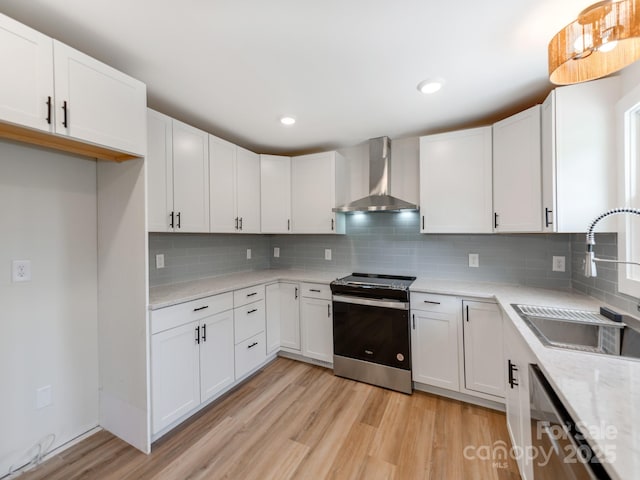 1606 N Rhyne St, Gastonia, NC 28054 - kitchen with stainless steel appliances, wall chimney range hood, light wood-style floors, tasteful backsplash, and recessed lighting